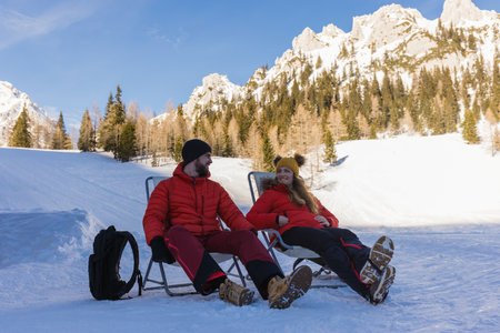 Happy couple enjoys a relaxing day outdoors in a stunning snowy landscapeの写真素材