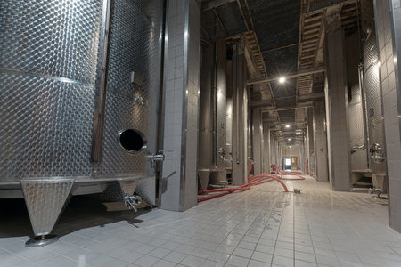 Modern wine cellar with new large inox stainless steel tanks for the fermentation.