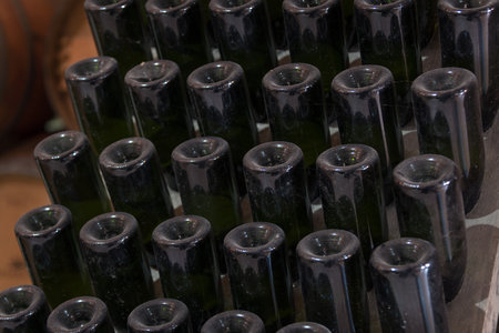 Authentic wine cellar for wine production and storage, with a high ceiling, stone floor, and big oak barrels lined in rowsの写真素材