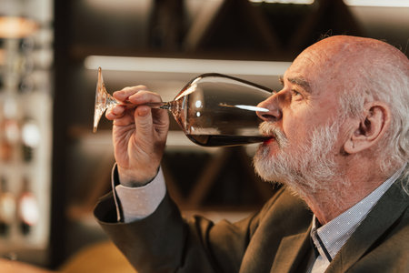 People drinking wine and eating cold cut meat in a wine cellar.の写真素材