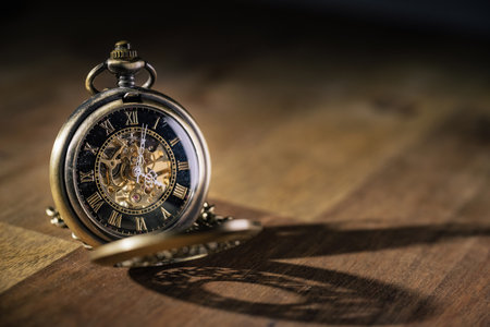 Beautiful open antique gold pocket watch ticking, on the golden background, close up shot. Future...
