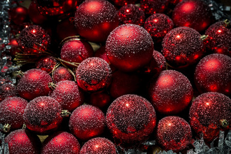 Christmas scene with snow falling on red tree balls decorations, close up shot. Happy New Year concept.の写真素材