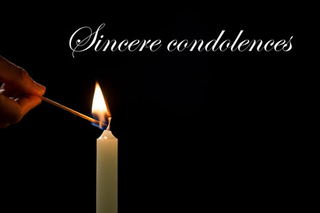 Sincere condolences card with candle and black background.