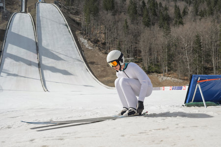 A ski jumper in the outrun at a training on snow.の写真素材
