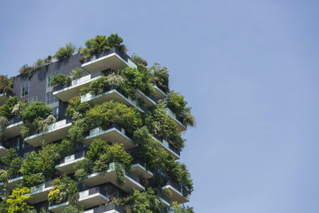 Residential tower, an example of modern architecture with various plants and tree-covered balconies....