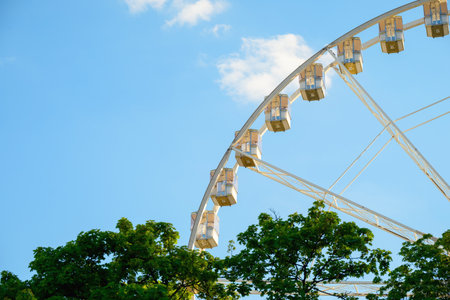 Visitors experience breathtaking views from the Budapest Eye against a bright blue sky. The...