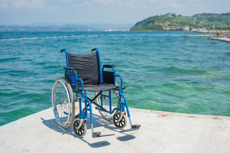 Empty wheelchairs, equipment for an accessible swimming pool and beach, mobility assistance for people with disability during summer vacation.の写真素材
