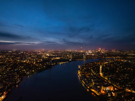 Twilight casts a magical glow over Londons skyline, highlighting the river and city lights as day transitions into night.の写真素材