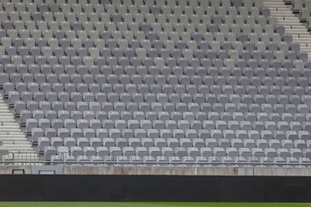 Grey seating fills a soccer stadium, ready for fans to enjoy the game.の写真素材