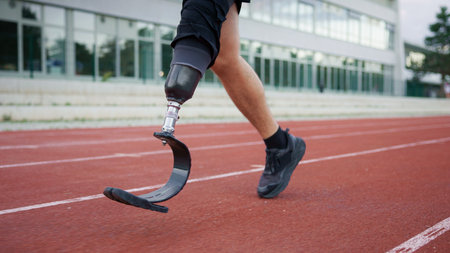 Athlete training on a running track using a prosthetic leg during the day, demonstrating movement...