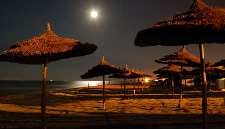 empty moonlit beach at night, light and shadowの写真素材