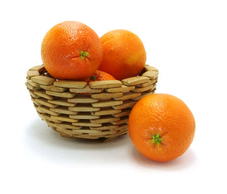 oranges in wooden bowl on a white background                       の写真素材