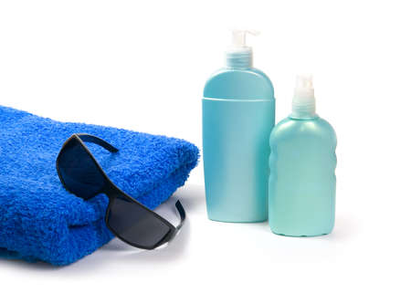 Sunglasses, sun lotion and towel on white background の写真素材