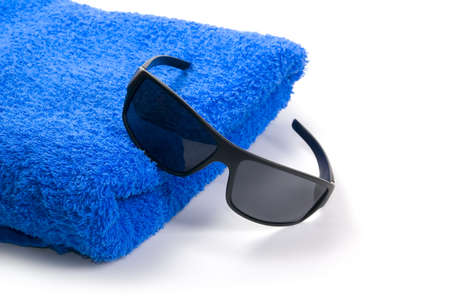 towel and sunglasses on a white backgroundの写真素材