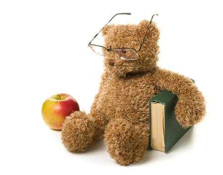 Clever teddy bear on a white background.の写真素材