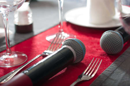 Microphone on the dining table. Concept of karaoke-restaurant. Blurred background.の写真素材