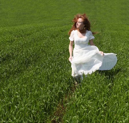 Girl running on field of grassの写真素材