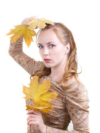 Young woman with maple leavesの写真素材