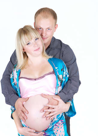 young pregnant woman with man isolated on white の写真素材