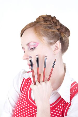 Young beautiful girl with cosmetics brushesの写真素材