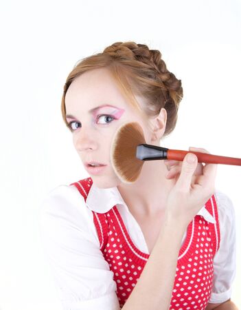 Young beautiful girl with cosmetics brushesの写真素材
