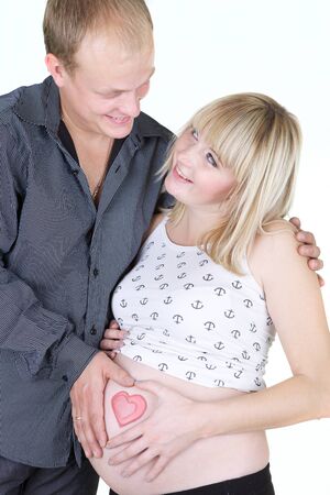young pregnant woman with man isolated on white の写真素材