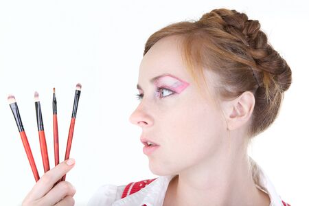 Young beautiful girl with cosmetics brushの写真素材