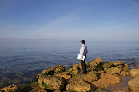 Young businessman on seashoreの写真素材