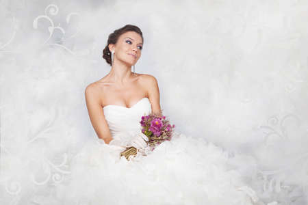 Brunet bride portrait with flowers in studioの写真素材