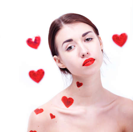 Brunette girl with red hearts isolated on whiteの写真素材