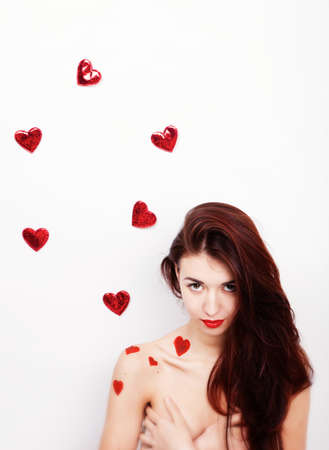 Brunette girl with red hearts isolated on whiteの写真素材