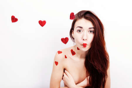 Brunette girl with red hearts isolated on whiteの写真素材