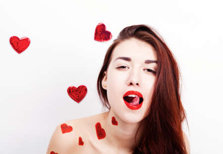 Brunette girl with red hearts isolated on whiteの写真素材
