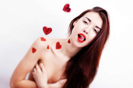Brunette girl with red hearts isolated on whiteの写真素材