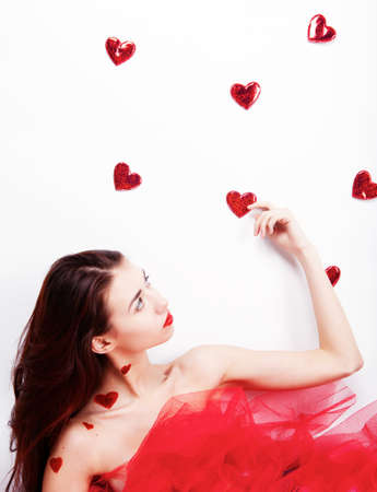 Brunette girl with red hearts isolated on whiteの写真素材