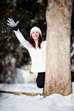 Girl playing with snow in parkの写真素材