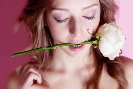 Girl with rose flower in teethsの写真素材