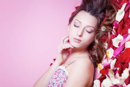 Beautiful girl with rose petalsの写真素材