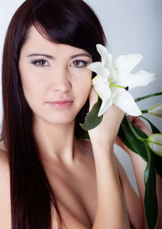 Girl with lily isolated on whiteの写真素材