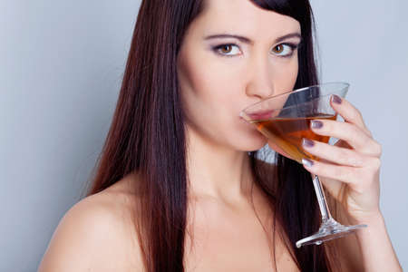 Girl drinking wine in studioの写真素材