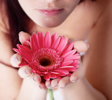 Girl with gerbera flower in studioの写真素材