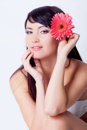 Girl with gerbera flower in studioの写真素材