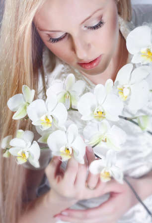 Girl with white orchid in studioの写真素材