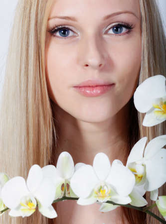 Girl with white orchid in studioの写真素材