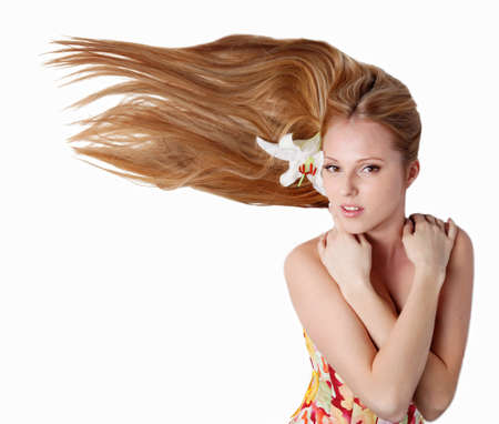 Beautiful blond girl with lily flower in studioの写真素材