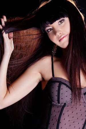 Beautiful girl in underweare holding her hairの写真素材