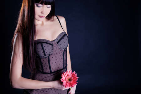 Beautiful girl in underweare with flower in handの写真素材