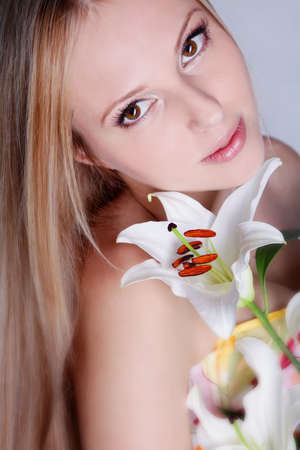 Beautiful blond girl with lily flowerの写真素材