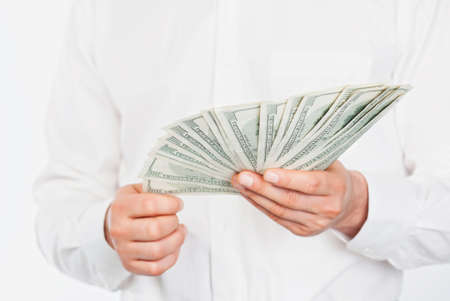 A man s hand holding a handful of dollarsの写真素材