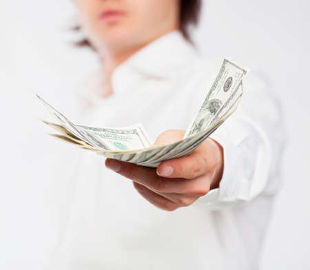 A man giving a handful of dollars.の写真素材
